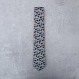Freedom silk tie designed by Niki Fulton. A bronze & blue graphical print