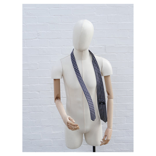 Kiss Kiss silk tie designed by Niki Fulton. A graphical print in deep purple. Seen here on a mannequin
